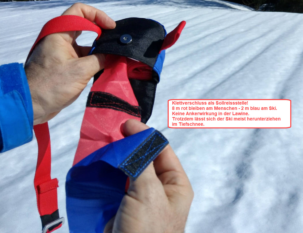 Sollreisstelle zwischen find---me LAwinenband (rot) und Tiefschneeband (blau). Verhindert Verletzungen im Tiefschnee und Ankerwirkung in der Lawine.
